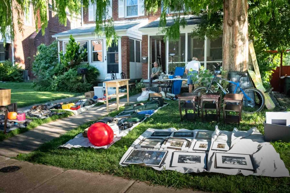 A small yard completely covered with household items at a yard sale